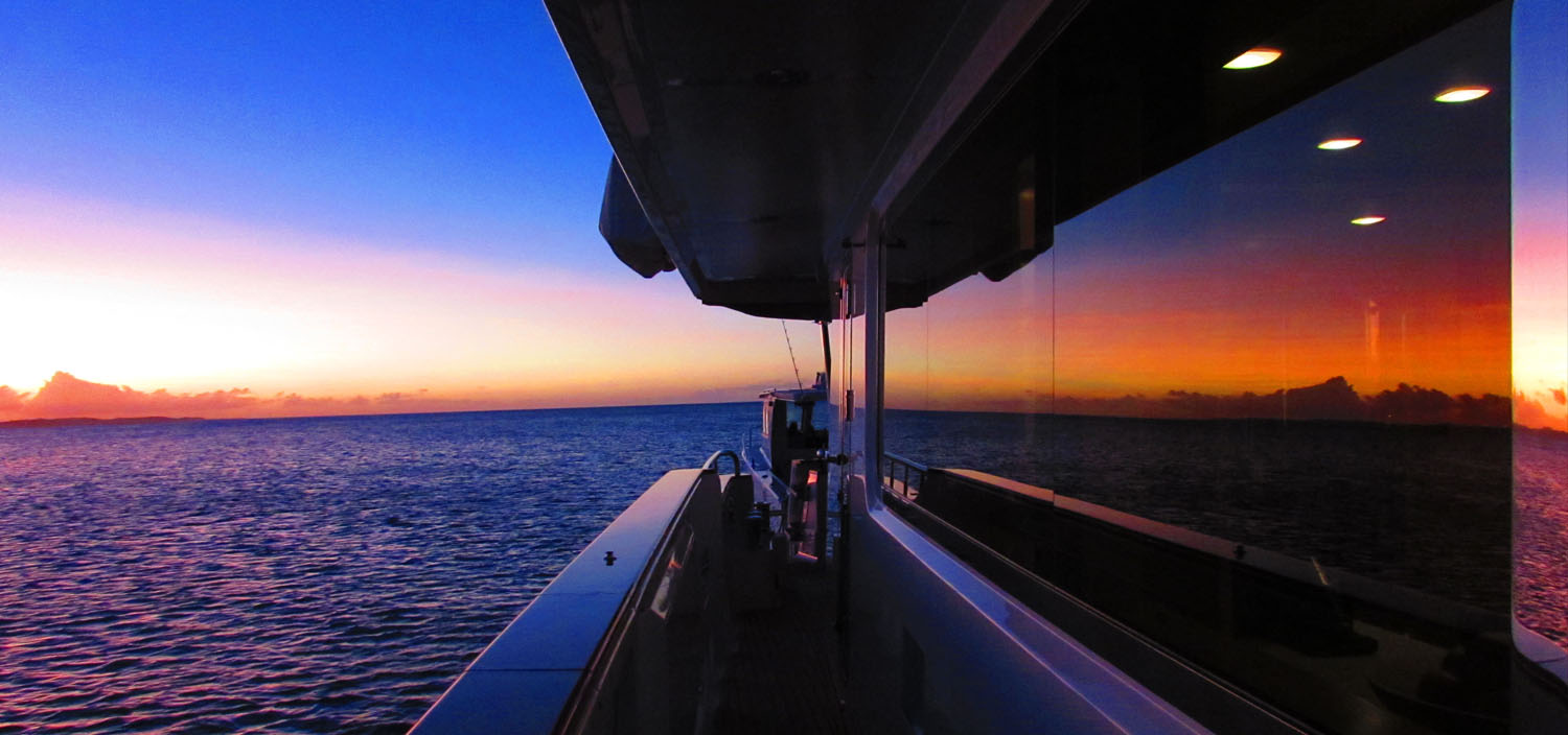 Admire pink shades at sunset on an Australasia yacht charter